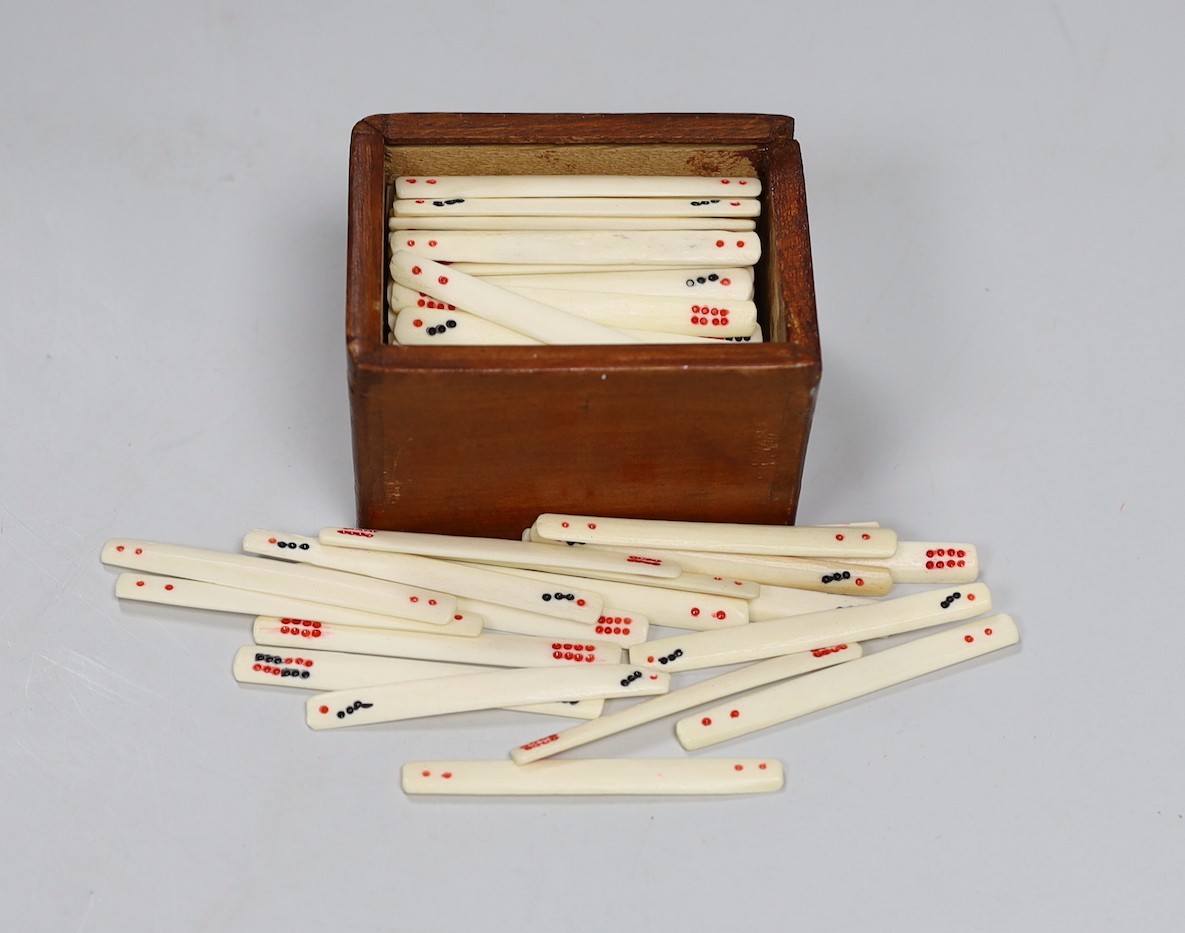 An early 20th century Chinese bone and bamboo mah jong set in two hardwood slide top boxes, largest 26.5cms wide x 5cms high